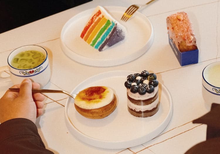 Drinks and assorted desserts on a table at CAFE NUL